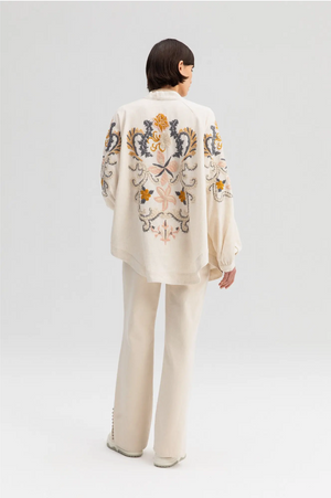 Off-white kimono jacket with embroidery in dusty pastel colors.